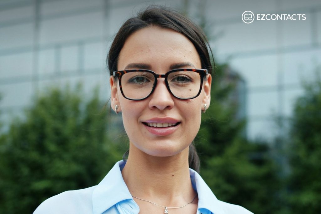 Woman with long face wearing oversized glasses
