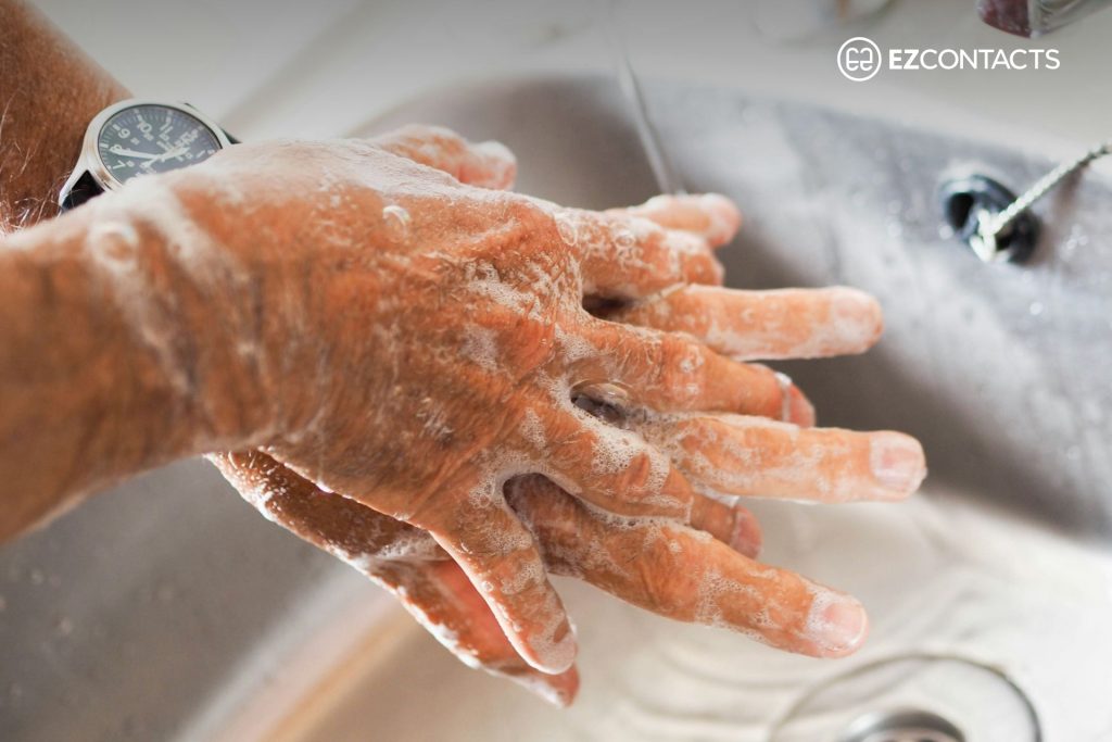 Person washing hands in sink