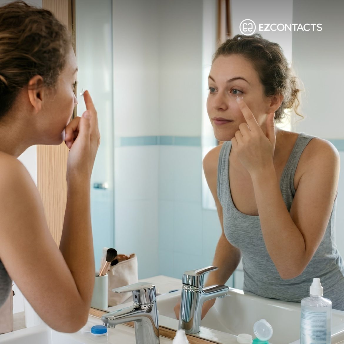 Woman looking in mirror and putting in contact