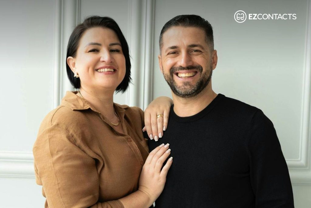 Woman in brown shirt and man in black shirt standing next to each other