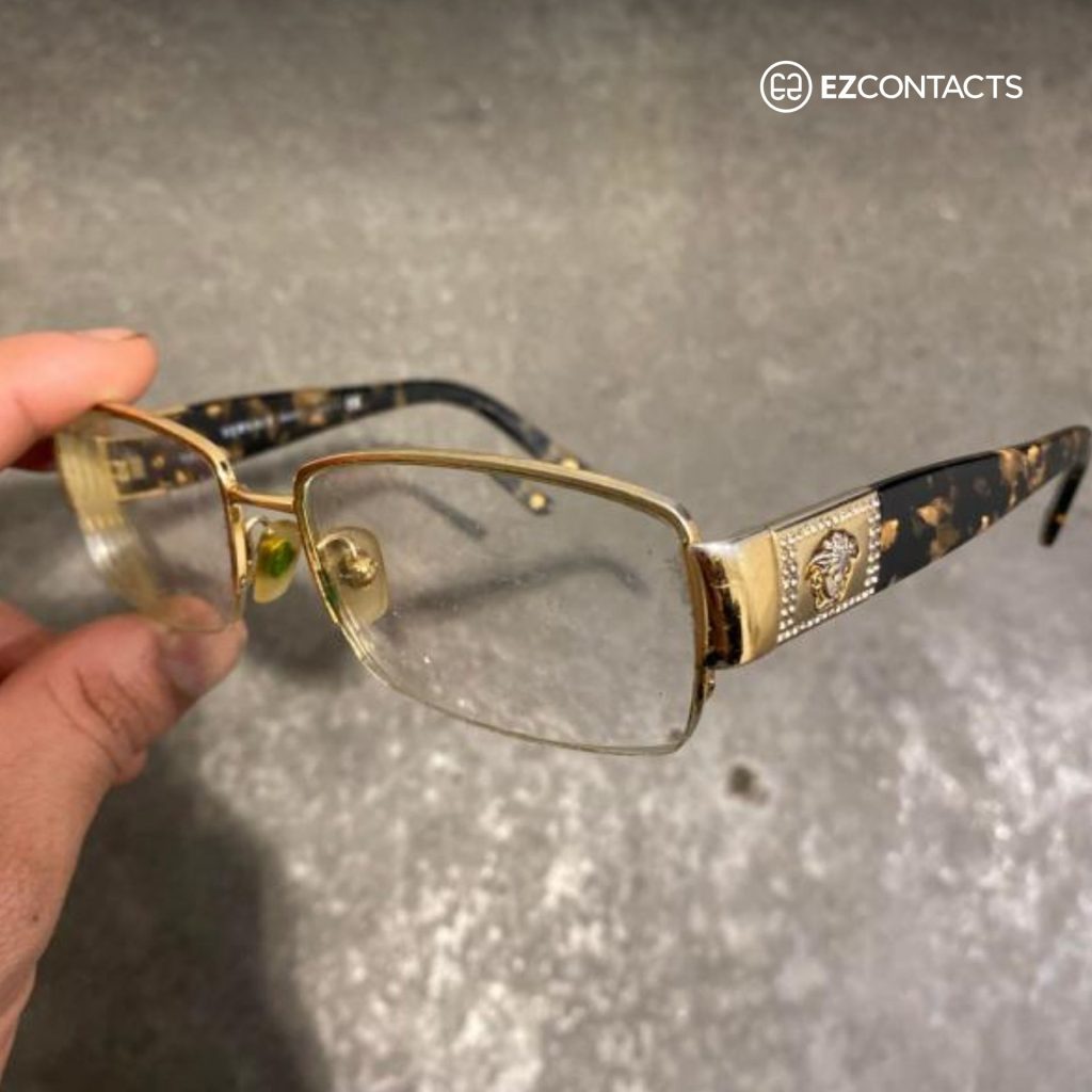 Customer holding Versace glasses