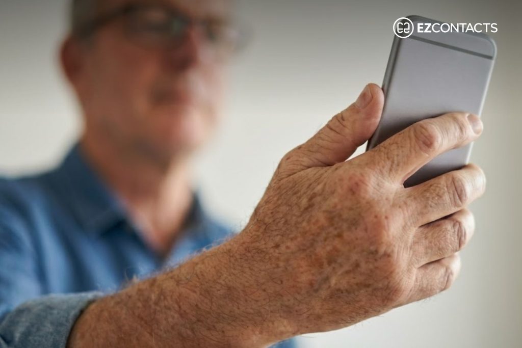 Man holding his phone at arm’s length