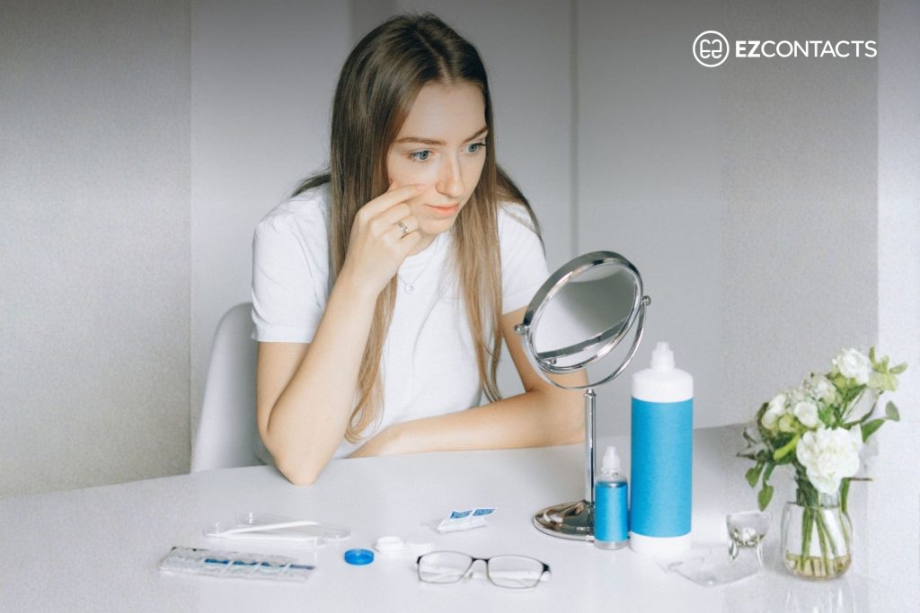 Woman putting in contact lens