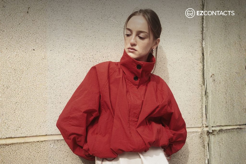 Woman in red funnel neck jacket