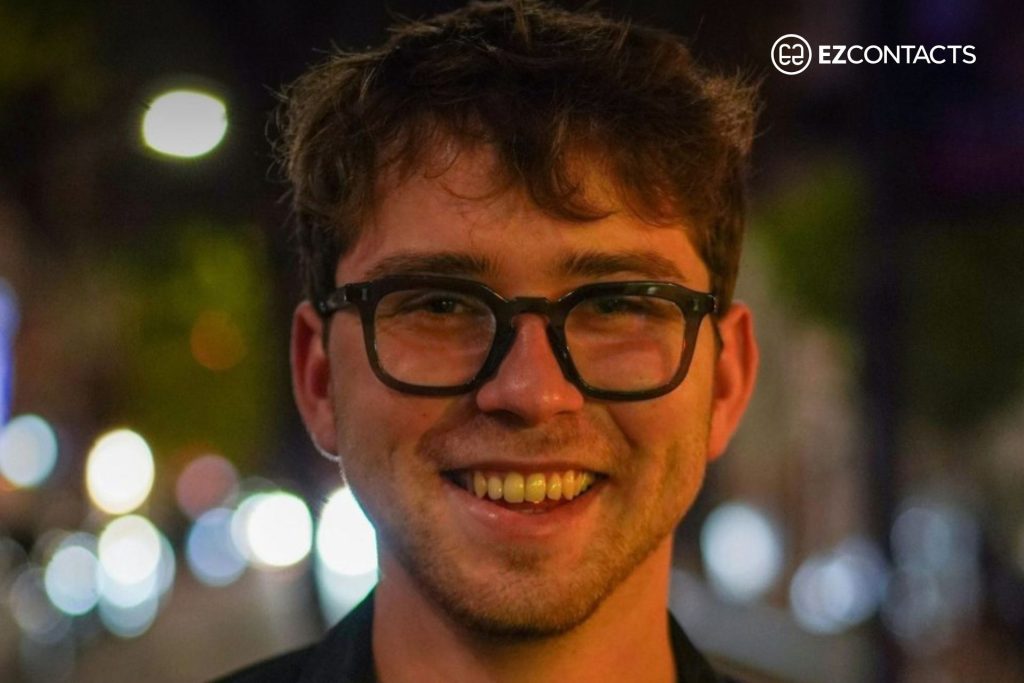 A smiling man wearing glasses