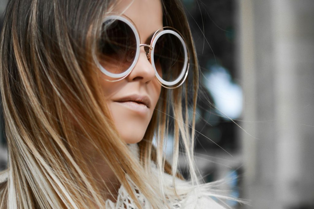 Woman wearing round oversized sunglasses
