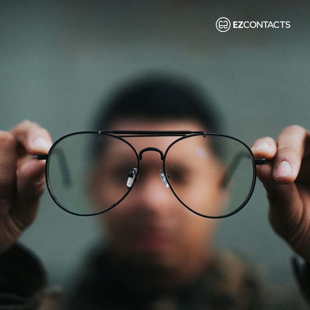 Man Holding a Pair of Glasses