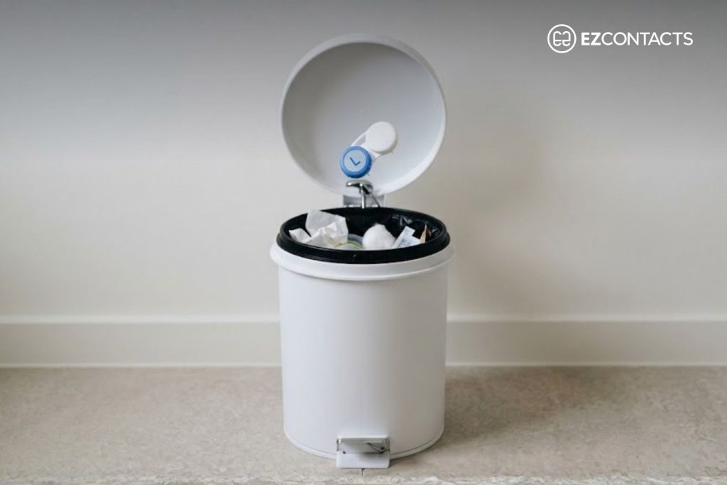 Contact Lens Case Being Discarded in Bathroom Bin